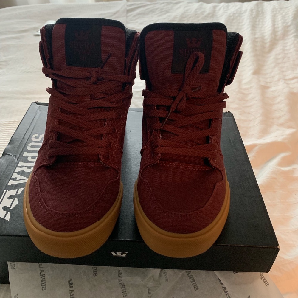 Supra burgundy high top shoes.